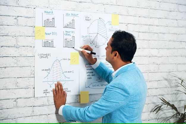 shoulder-shot-business-man-drawing-diagrams-wall-poster_1098-18524