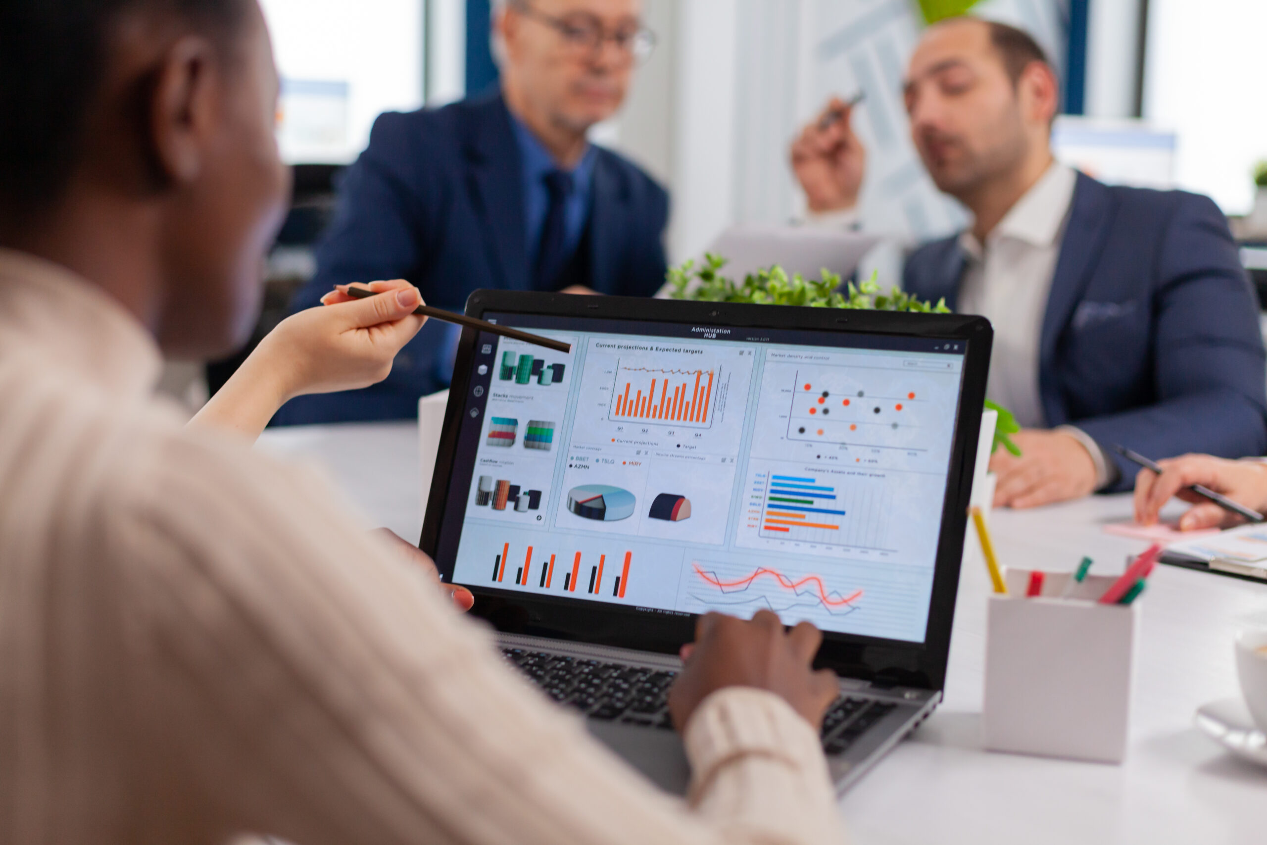 Multi-ethnic business team sitting at table in office center speaking